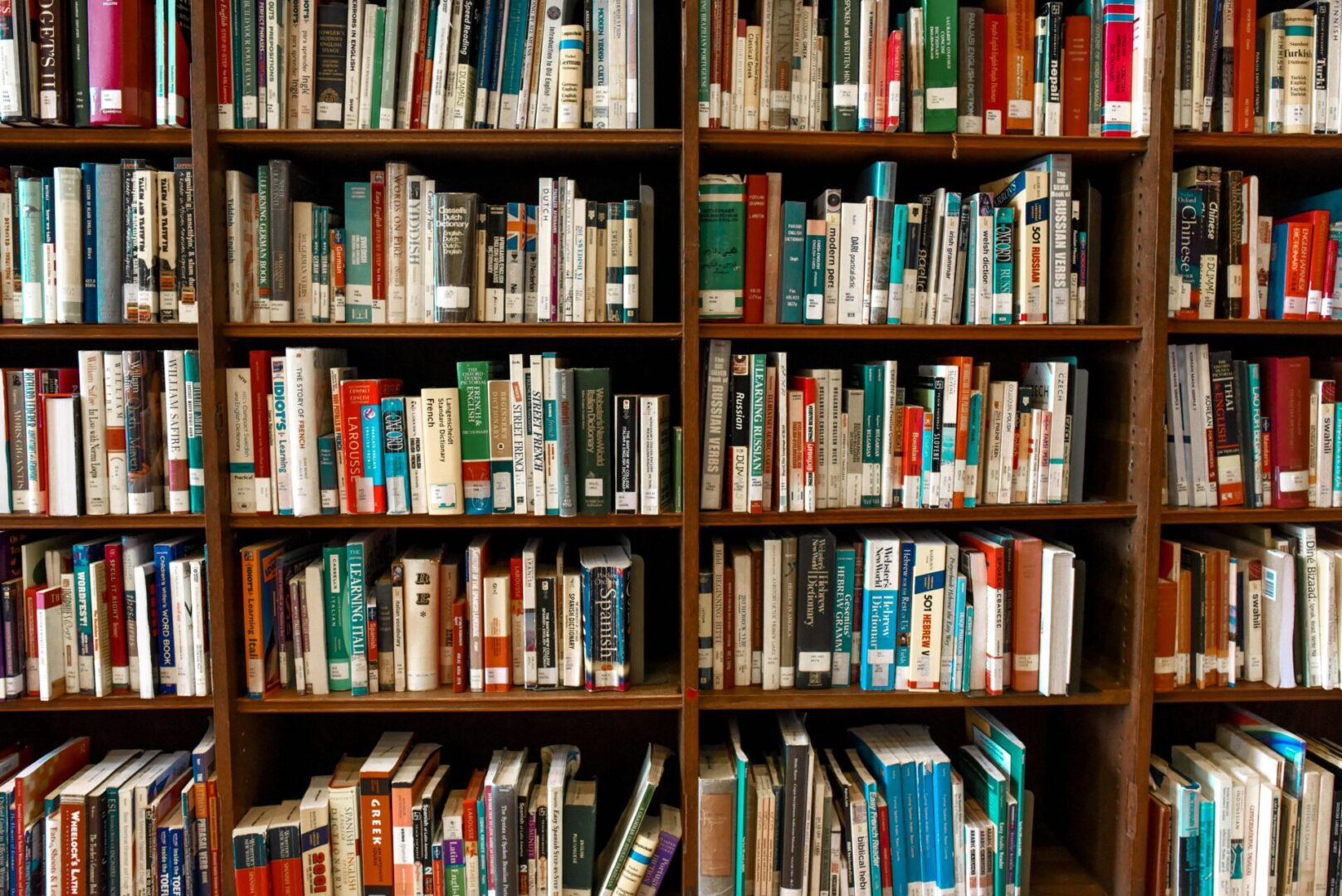 pexels-element5-1370295 A bookshelf filled with a variety of books, including paperbacks and hardcovers, organized in rows.